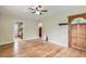 Bright and airy living room featuring hardwood floors, a ceiling fan, and a wood door at 1325 Geneva St, Aurora, CO 80010