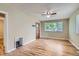 Bright living room featuring hardwood floors, a ceiling fan, and natural light at 1325 Geneva St, Aurora, CO 80010