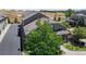 Overhead shot showcases a well-kept residential area with neutral-toned townhomes, green lawns, and a peaceful ambiance at 4718 Raven Run, Broomfield, CO 80023