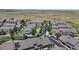 Aerial view shows a residential neighborhood with neatly arranged homes, landscaped streets, and a sense of community at 4718 Raven Run, Broomfield, CO 80023