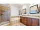 Bathroom with tiled shower, soaking tub, double sinks, and tiled accents at 4718 Raven Run, Broomfield, CO 80023