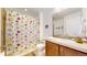 Bathroom featuring a vanity, tile floors and a shower with a decorative shower curtain at 4718 Raven Run, Broomfield, CO 80023