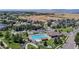 Aerial view of a sparkling community pool with lounge chairs and recreational area at 4718 Raven Run, Broomfield, CO 80023
