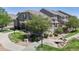 Inviting townhome with mature landscaping, rock garden, and charming walkway, creating a serene outdoor space at 4718 Raven Run, Broomfield, CO 80023