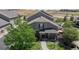 Attractive two-story house with a covered front porch and well-kept lawn in a residential area at 4718 Raven Run, Broomfield, CO 80023