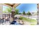 Inviting front porch with comfortable seating, decorative stone columns, and a view of the neighborhood at 4718 Raven Run, Broomfield, CO 80023