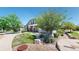 Landscaped front yard with mature trees, lush grass, and a charming facade with stone accents at 4718 Raven Run, Broomfield, CO 80023