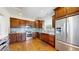 Spacious kitchen featuring stainless steel appliances, a gas range, and hardwood floors at 4718 Raven Run, Broomfield, CO 80023