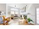 Bright living room featuring a fireplace, large windows, hardwood floors and vaulted ceiling at 4718 Raven Run, Broomfield, CO 80023