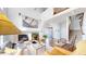 Bright living room featuring a fireplace, staircase, and large windows at 4718 Raven Run, Broomfield, CO 80023