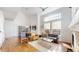 Spacious living room with hardwood floors, high ceilings, and open layout to the dining area at 4718 Raven Run, Broomfield, CO 80023