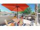 Outdoor patio with seating and an umbrella for shade at 4718 Raven Run, Broomfield, CO 80023
