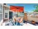 Inviting patio with dining set, orange umbrella, stylish decor, and easy access indoors, perfect for relaxing or entertaining at 4718 Raven Run, Broomfield, CO 80023