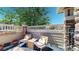 Relaxing patio with chairs, cushions and a view of trees at 4718 Raven Run, Broomfield, CO 80023