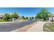 Serene street view with well-maintained homes, lush trees, and landscaping enhancing the neighborhood's appeal at 4718 Raven Run, Broomfield, CO 80023