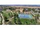 Aerial view of community tennis courts surrounded by lush greenery and walking paths, ideal for recreation and fitness at 4718 Raven Run, Broomfield, CO 80023
