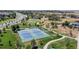 Overhead view features tennis courts within a green community park with walking paths, providing a scenic recreational space at 4718 Raven Run, Broomfield, CO 80023
