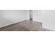 Bright bedroom featuring wood-look vinyl flooring, neutral paint, and closet at 7185 S Gaylord St # G13, Littleton, CO 80122