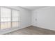 Bedroom featuring neutral walls, carpet, and a large window at 7185 S Gaylord St # G13, Littleton, CO 80122
