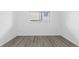 Bedroom with a bright window, and wood-look vinyl flooring at 7185 S Gaylord St # G13, Littleton, CO 80122