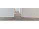 Hallway with wood-look vinyl flooring and neutral paint at 7185 S Gaylord St # G13, Littleton, CO 80122