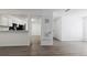 An open-concept living room flows to the kitchen with attractive wood-look floors at 7185 S Gaylord St # G13, Littleton, CO 80122