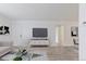 Spacious living room with a modern white media center, offering a comfortable and stylish space at 7185 S Gaylord St # G13, Littleton, CO 80122
