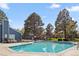 A bright pool with lounge chairs in a community setting with mature landscaping on a beautiful sunny day at 7185 S Gaylord St # G13, Littleton, CO 80122