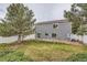 Large backyard with lush grass, mature trees, and a patio area, ideal for relaxation and entertainment at 5120 Perth St, Denver, CO 80249