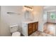 Bathroom with oak vanity, patterned tile floor, and chrome fixtures at 5120 Perth St, Denver, CO 80249
