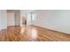 Bedroom featuring hardwood floors, a connecting bathroom, and a window providing natural light at 5120 Perth St, Denver, CO 80249