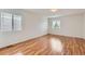 Spacious bedroom with hardwood floors, and multiple windows that provide ample natural light at 5120 Perth St, Denver, CO 80249