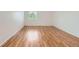 Bright bedroom featuring gleaming hardwood floors, white trim, and natural light at 5120 Perth St, Denver, CO 80249