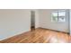 Bedroom with hardwood floors, closet, and natural light from a window at 5120 Perth St, Denver, CO 80249