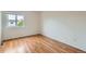 Bedroom with hardwood floors, neutral walls, and window with exterior view at 5120 Perth St, Denver, CO 80249