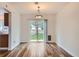 Bright dining area with wood-look floors and sliding glass doors leading to outdoors at 5120 Perth St, Denver, CO 80249