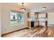 Bright kitchen featuring white cabinets, black appliances, modern flooring, and plenty of natural light at 5120 Perth St, Denver, CO 80249