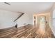 Spacious open concept living space with wood-look flooring and staircase at 5120 Perth St, Denver, CO 80249