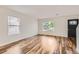 Bright and airy living room with wood-look floors and large windows at 5120 Perth St, Denver, CO 80249