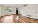 Open living space with wood-look floors, natural light and access to upstairs at 5120 Perth St, Denver, CO 80249