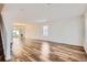 Sun-filled living room featuring wood-look flooring and a neutral color palette at 5120 Perth St, Denver, CO 80249