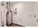Utility room with water heater, washer, dryer hookups, and ample space for laundry needs at 5120 Perth St, Denver, CO 80249