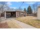 Cozy brick home featuring a backyard with a covered patio and hammock, perfect for relaxation at 2545 W 45Th Ave, Denver, CO 80211