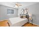Bright bedroom featuring neutral decor, hardwood floors, and a ceiling fan at 2545 W 45Th Ave, Denver, CO 80211