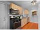 Modern kitchen with stainless steel appliances, light wood cabinets, and stylish fixtures at 2545 W 45Th Ave, Denver, CO 80211
