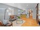 Bright living room with wood floors, modern furniture, and bar with yellow stools at 2545 W 45Th Ave, Denver, CO 80211