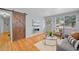 Cozy living room featuring a sliding barn door, modern fireplace, and natural light at 2545 W 45Th Ave, Denver, CO 80211
