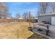 Backyard featuring a lush lawn, picnic table, concrete patio, and a gray house with a wooden fence at 6835 W 55Th Pl, Arvada, CO 80002