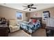 Bedroom featuring a comfortable queen bed, light walls, and a ceiling fan for a cozy atmosphere at 6835 W 55Th Pl, Arvada, CO 80002