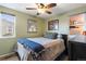 Cozy bedroom with neutral walls, ceiling fan, and a comfortable bed, creating a relaxing atmosphere at 6835 W 55Th Pl, Arvada, CO 80002